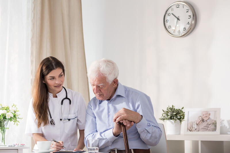 Navigating New York's Community Medicaid Program for In-Home Care New York's Community Medicaid Program for In-Home Care - elderly man sitting with a health care aide