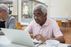 Medicaid planning, image of a senior man working on laptop